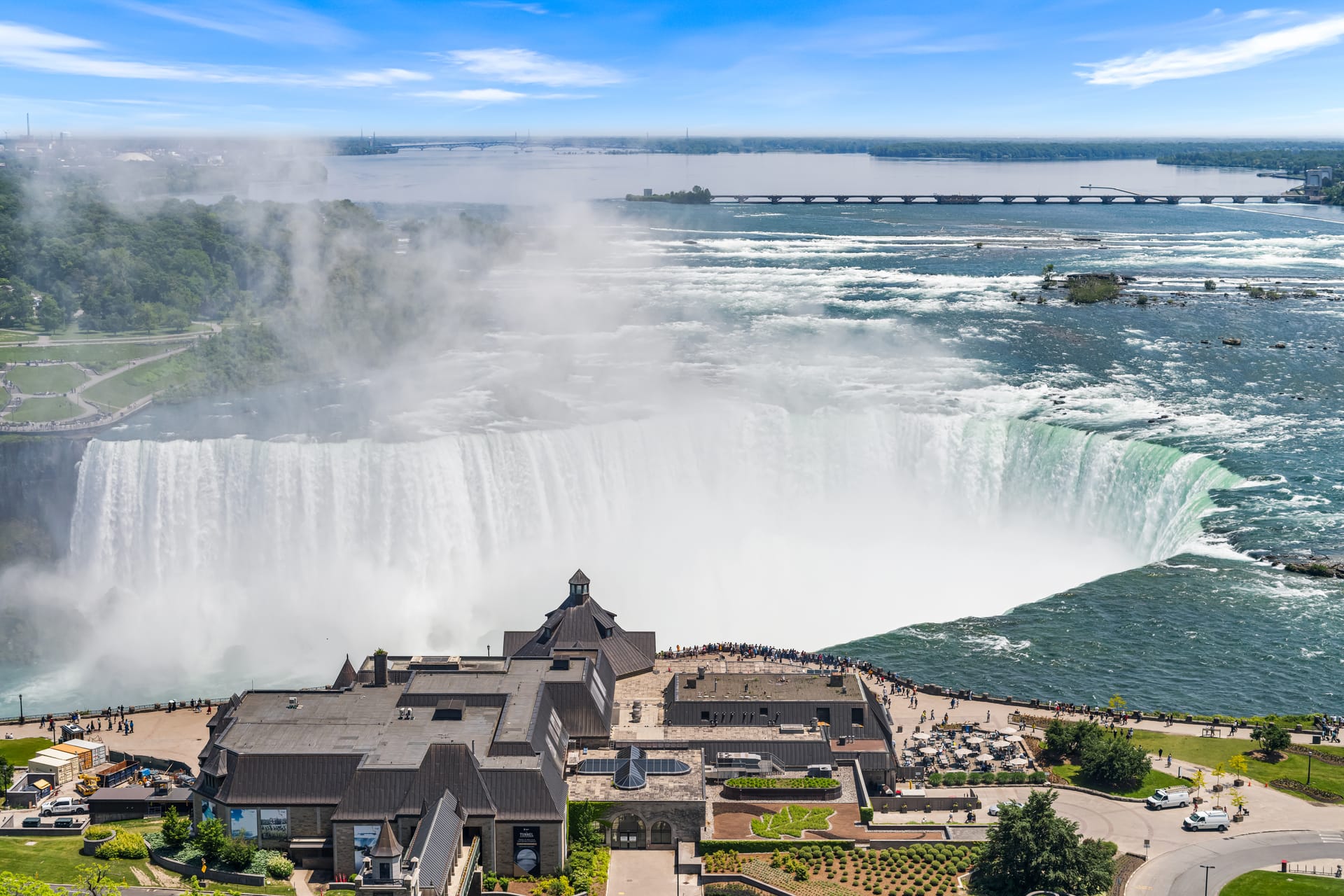 A view overlooking the Niagara Horseshoe, with people viewing from the walkway.